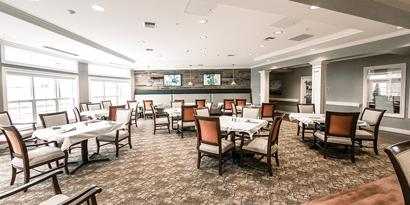 Spacious restaurant interior with tables and elegant decor.